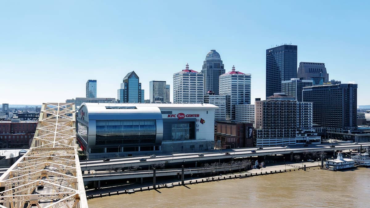 The downtown Louisville, Kentucky skyline across the Ohio River, with the KFC Yum! Center and the George Rogers Clark Memorial Bridge
